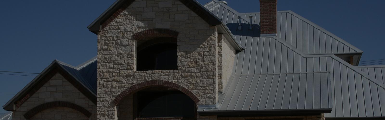 Stone home with a gray metal roof
