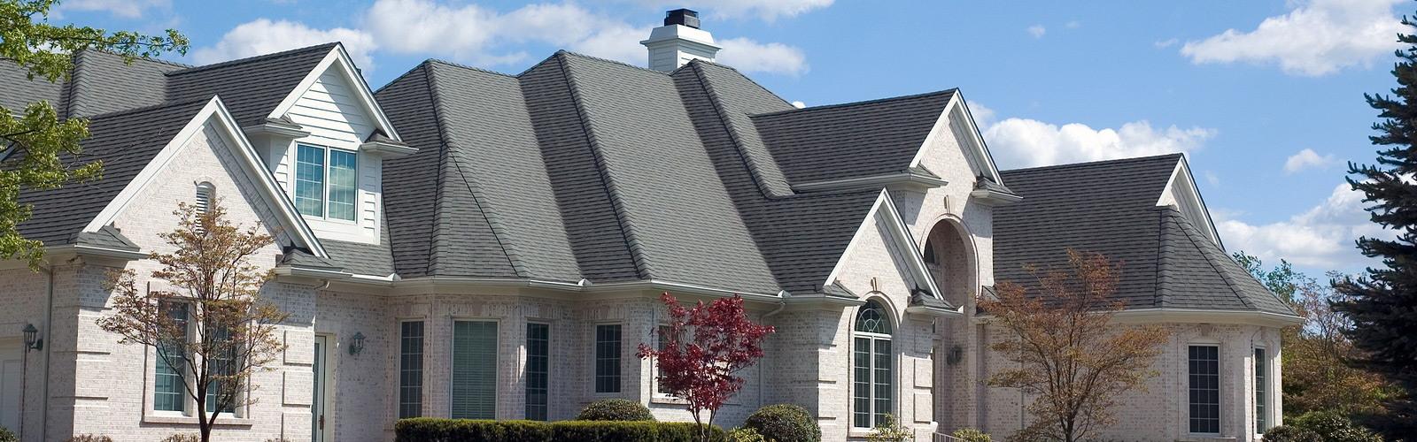 Large higher-end home with a gray shingle roof